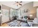 Cozy living room featuring hardwood floors, vaulted ceilings, natural light, and stylish decor at 11332 E 111Th Ave, Commerce City, CO 80640