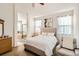Serene main bedroom featuring natural light and an en-suite bathroom with a soaking tub at 11332 E 111Th Ave, Commerce City, CO 80640