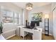 Bright home office with a large window, a modern desk, and stylish lighting at 11332 E 111Th Ave, Commerce City, CO 80640