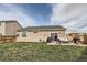 Spacious backyard with a patio and lush green lawn, providing ample space for outdoor activities at 5490 Suffolk Ave, Castle Rock, CO 80104