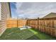 The backyard features a fenced in yard with artificial turf and a fire pit at 5490 Suffolk Ave, Castle Rock, CO 80104