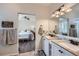 Well-lit bathroom featuring double sinks, granite countertops, and easy access to the bedroom at 5490 Suffolk Ave, Castle Rock, CO 80104
