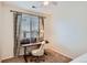 Study with patterned curtains, wood desk, neutral chair, and carpet flooring at 5490 Suffolk Ave, Castle Rock, CO 80104