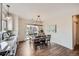 Bright kitchen and dining area featuring hardwood floors, modern lighting, and a sliding door to the backyard at 5490 Suffolk Ave, Castle Rock, CO 80104