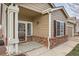Cozy home entrance with brick accents and a welcoming 'hello' mat, leading into a bright and inviting interior at 5490 Suffolk Ave, Castle Rock, CO 80104