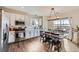 Modern kitchen with stainless steel appliances, hardwood floors, stylish backsplash, and abundant natural light at 5490 Suffolk Ave, Castle Rock, CO 80104