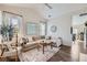 Sunlit living room with vaulted ceilings, modern decor, a cozy fireplace, and an open airy layout at 5490 Suffolk Ave, Castle Rock, CO 80104