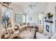Sunlit living room with vaulted ceilings, modern decor, a cozy fireplace, and an open airy layout at 5490 Suffolk Ave, Castle Rock, CO 80104
