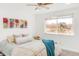 Light-filled bedroom featuring a large window, neutral tones, and ceiling fan at 6378 S Benton Way, Littleton, CO 80123