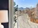 Street view showcases the neighborhood's tranquil setting, tree-lined streets, and distant mountain views for a peaceful environment at 6378 S Benton Way, Littleton, CO 80123