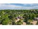 Aerial view of the home and circular driveway nestled among mature trees and lush landscaping in a neighborhood at 8836 Marathon Rd, Longmont, CO 80503