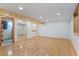 Open basement space with hardwood floors, exposed beams and natural light at 8836 Marathon Rd, Longmont, CO 80503