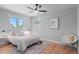 Bright bedroom with large windows, ceiling fan, and stylish decor at 8836 Marathon Rd, Longmont, CO 80503