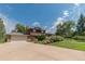 Two-story home with a driveway, garage, landscaped yard, and charming mix of brick and wood exterior at 8836 Marathon Rd, Longmont, CO 80503