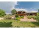 Charming two-story home with a well-manicured lawn, mature trees, and beautiful landscaping creating an inviting curb appeal at 8836 Marathon Rd, Longmont, CO 80503