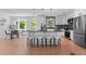 Kitchen island featuring stools and sleek countertops, with a dining area nearby, creating the perfect gathering space at 8836 Marathon Rd, Longmont, CO 80503