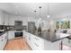 Bright, modern kitchen featuring a large island with seating and stainless steel appliances, perfect for entertaining at 8836 Marathon Rd, Longmont, CO 80503