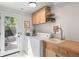 Well-organized laundry room featuring built-in cabinets, sink, and a convenient door to the exterior at 8836 Marathon Rd, Longmont, CO 80503