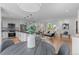 Bright and airy living room features a modern kitchen with stainless steel appliances and an open floor plan at 8836 Marathon Rd, Longmont, CO 80503