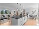 Modern kitchen island open to a cozy living and dining area, creating an ideal space for Gathering and gatherings at 8836 Marathon Rd, Longmont, CO 80503