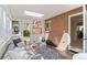 Inviting sunroom with a comfortable seating area, skylight, and access to the backyard at 8836 Marathon Rd, Longmont, CO 80503