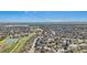 Wide aerial shot showcasing a residential neighborhood with tree-lined streets and green spaces at 9731 W Polk Dr, Littleton, CO 80123