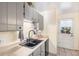 Galley kitchen with stainless steel appliances, neutral colors, and lots of storage at 9731 W Polk Dr, Littleton, CO 80123