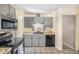 The kitchen features gray cabinets, stainless steel appliances, and a black sink at 9731 W Polk Dr, Littleton, CO 80123