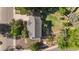 Aerial shot of the home featuring well manicured lawn, backyard play area, and mature trees at 308 Oswego St, Aurora, CO 80010