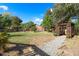 Large backyard with grass, mature trees, and a gazebo at 308 Oswego St, Aurora, CO 80010