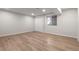 Finished basement with vinyl flooring, white walls, and a window at 308 Oswego St, Aurora, CO 80010