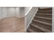 Finished basement area with wood-look floors, white trim, and carpeted stairs at 308 Oswego St, Aurora, CO 80010
