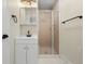 Updated bathroom featuring a shower with glass door and modern fixtures at 308 Oswego St, Aurora, CO 80010