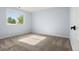 Simple bedroom with neutral-toned walls and carpet and a bright window view at 308 Oswego St, Aurora, CO 80010