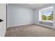 Bright bedroom with neutral carpet and walls featuring a window nook with storage at 308 Oswego St, Aurora, CO 80010