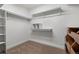 Walk-in closet with shelves, hanging rods, and carpet flooring at 308 Oswego St, Aurora, CO 80010