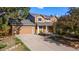 Inviting home featuring a spacious driveway and attached garage at 308 Oswego St, Aurora, CO 80010
