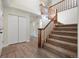 Bright foyer featuring carpeted stairs and wood-style laminate flooring at 308 Oswego St, Aurora, CO 80010