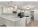 Contemporary kitchen with stainless steel appliances, white quartz countertops, and an island at 308 Oswego St, Aurora, CO 80010