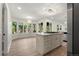 Bright, open kitchen with a central island, eat-in nook, and stainless steel appliances at 308 Oswego St, Aurora, CO 80010