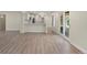Open-concept living area with light-toned flooring and access to an outdoor patio at 308 Oswego St, Aurora, CO 80010