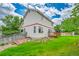 A spacious backyard with lush lawn and low wooden fence offers outdoor relaxation at 5023 Goshawk Ct, Brighton, CO 80601