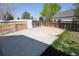 Backyard area with large concrete pad, natural lighting, and fenced in area at 5023 Goshawk Ct, Brighton, CO 80601