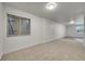 Finished basement with tile accent and windows at 5023 Goshawk Ct, Brighton, CO 80601