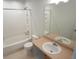 A clean bathroom features a shower-tub combo, toilet, and vanity with sink at 5023 Goshawk Ct, Brighton, CO 80601