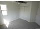 This bedroom features neutral carpet, one window, and a closet at 5023 Goshawk Ct, Brighton, CO 80601