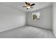Bright bedroom with neutral carpet, a ceiling fan, and a window offering natural light at 5023 Goshawk Ct, Brighton, CO 80601