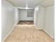 Bedroom with carpeted flooring leading into a tiled area, neutral walls, and natural light at 5023 Goshawk Ct, Brighton, CO 80601