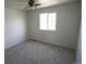 The bedroom features neutral walls, carpet, ceiling fan and a window at 5023 Goshawk Ct, Brighton, CO 80601