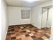 Bedroom with neutral walls, and beautiful, warm-toned tile flooring at 5023 Goshawk Ct, Brighton, CO 80601